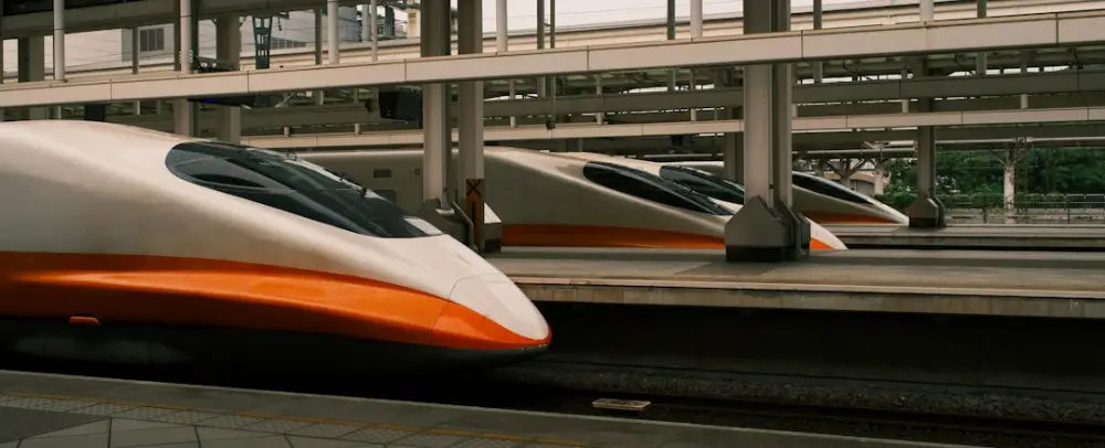High-speed trains are stopped at a platform, illustrating connected rail operations